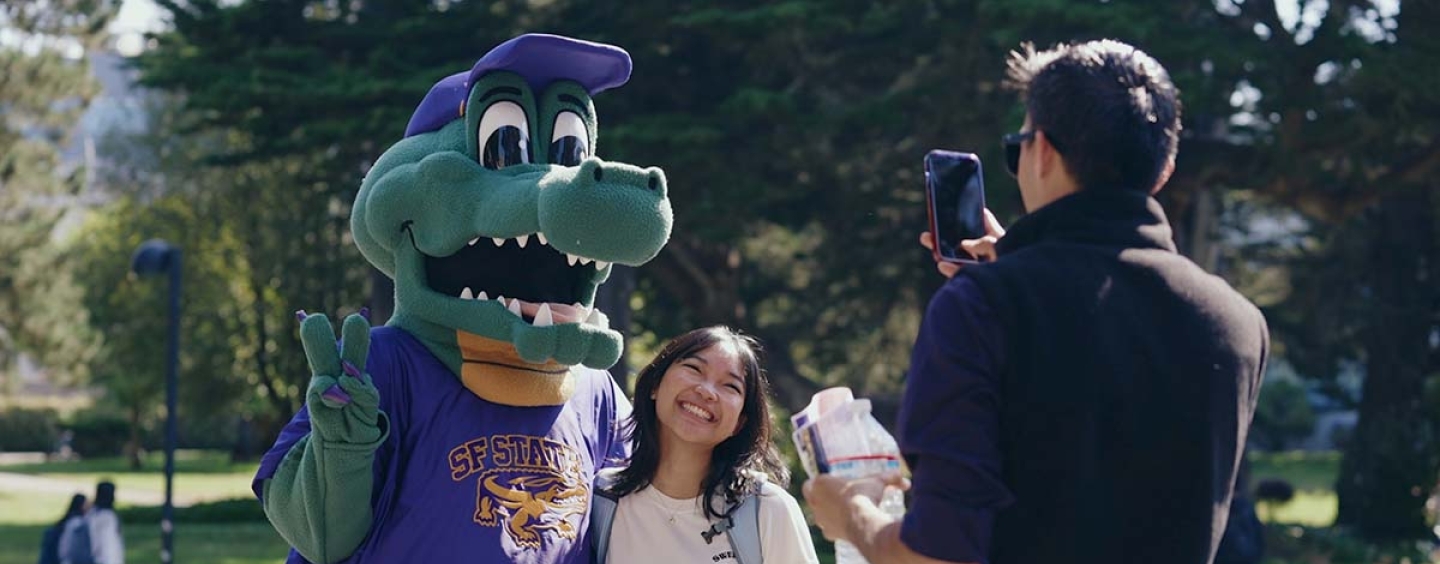 Alli Gator poses with a student for a photo in the Quad 