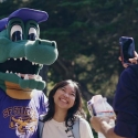 Alli Gator poses with a student for a photo in the Quad 