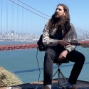 Nate site with a guitair with the Golden Gate Bridge in the background