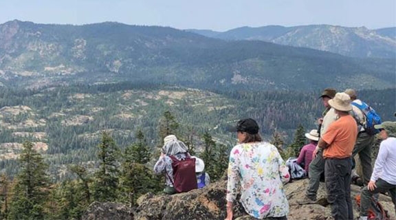 People star out at a valley in the Sierra 